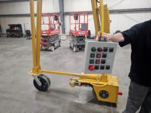 Control pendant and motorized wheel assembly on a 5-ton trackless steerable gantry crane.